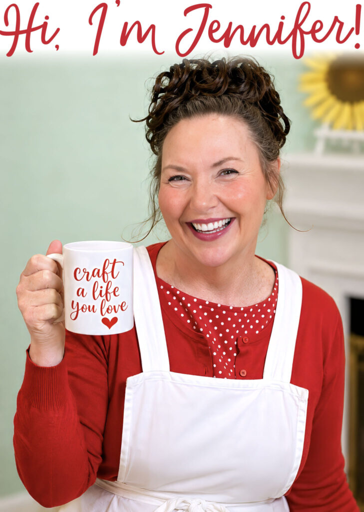 A welcoming and smiling image of Jennifer Maker with a mug that says "craft a life you love"